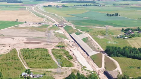 rail baltica railway spanning in lihuania farmlands, aerial view