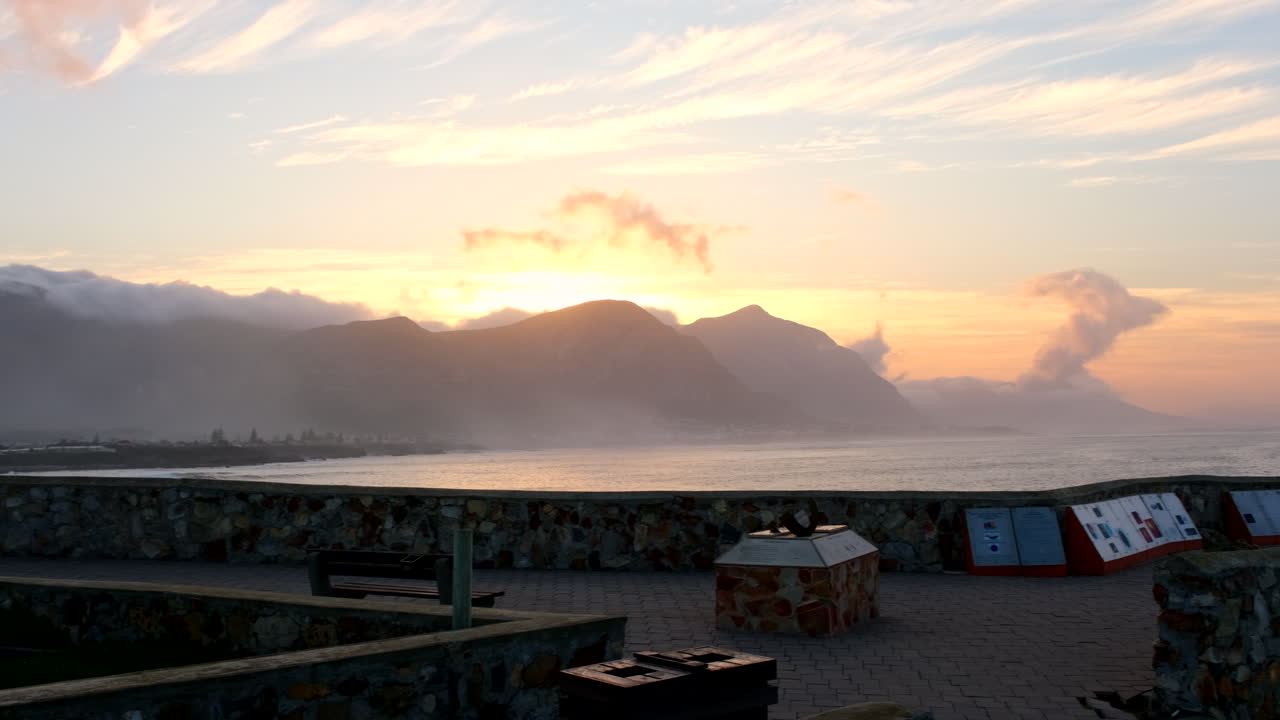 Sunrise view behind mountains over Walker Bay Hermanus from Gearing's Point