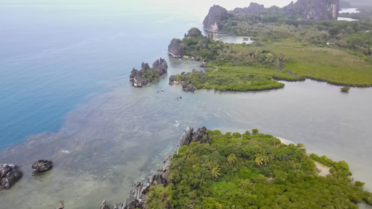 Drone aerial panning up at La Poule in New Caledonia with blue water