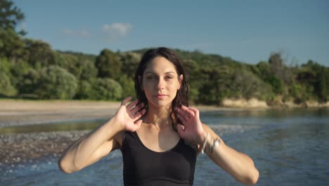 Caucasian-female-girl-looking-into-camera,-beach-background,-natural-light-sunny-day,-slow-motion