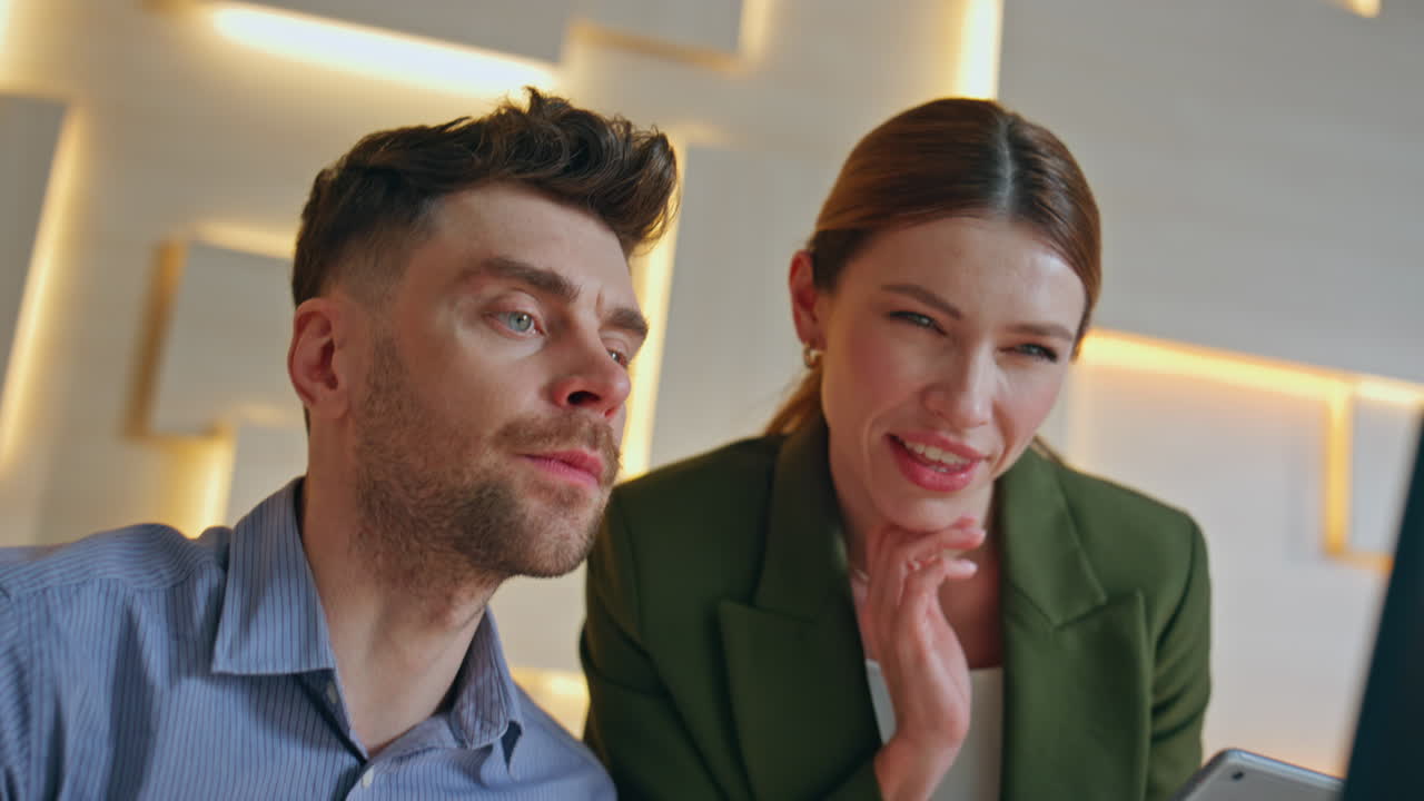 Couple colleagues discussing ideas interacting together in modern office closeup