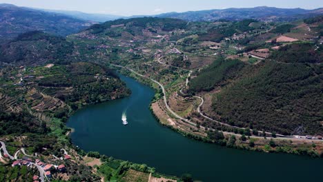 douro river valley with cruising ship and towns on hilly shorelines