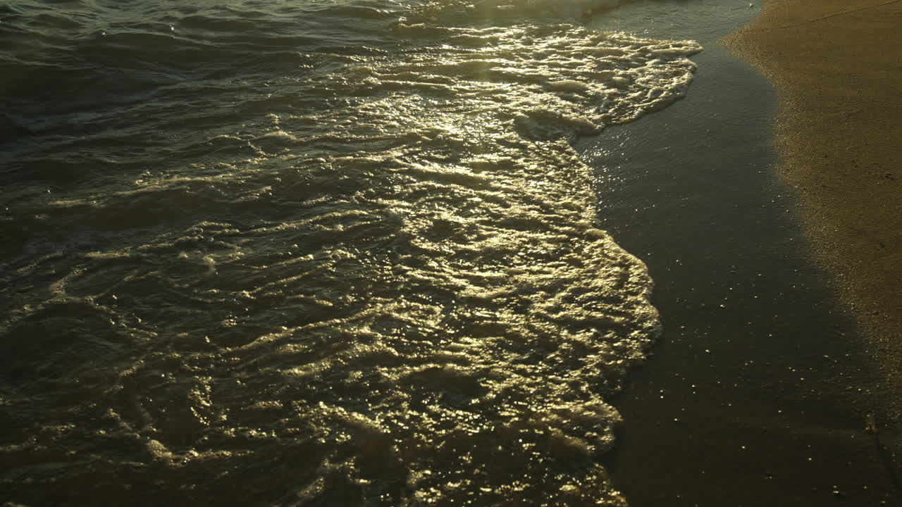 Waves at the beach at sunset