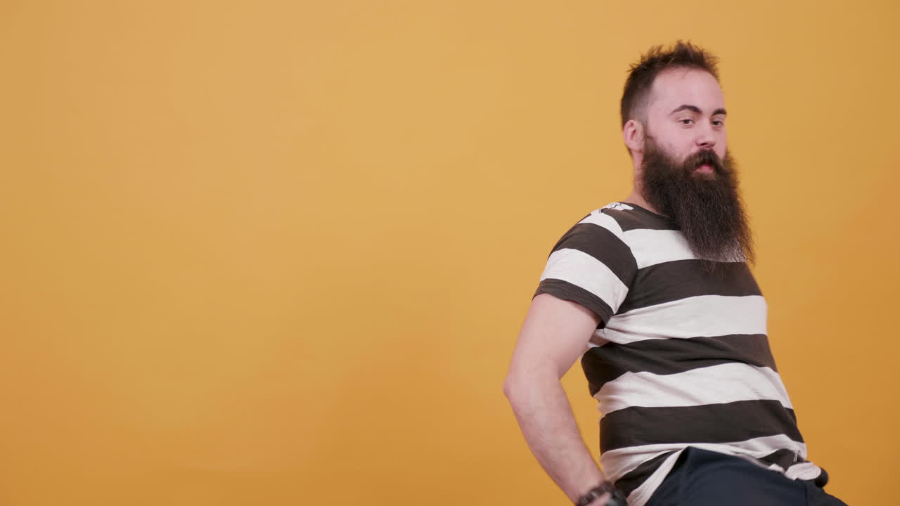 Man with beard in striped shirt