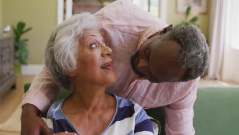 Senior-African-American-husband-and-mixed-race-wife-spending-time-together,-hugging-and-smiling