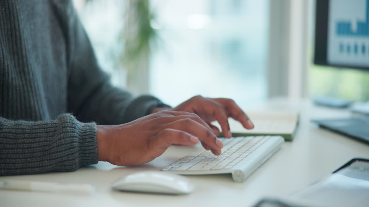 Close-up of Hands Typing on Computer Keyboard in Office