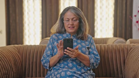 Happy-Indian-old-woman-using-mobile-phone