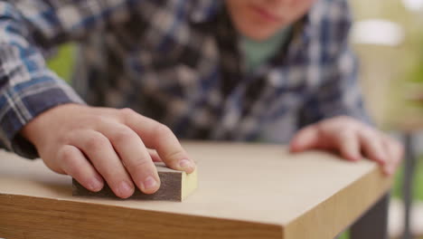 man sanding a wood table