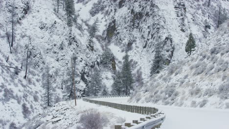 suv drives by on snow covered mountain road in winter time