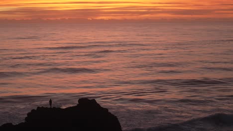 sunrise at the ocean with silhouette, golden sun reflexion orange sky, beautiful start of day
