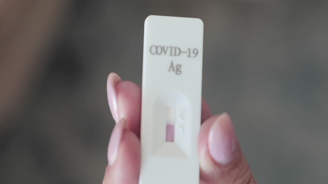 Hand Holding Antigen Rapid Test Cassette Kit And Waiting For Result For COVID-19 Testing