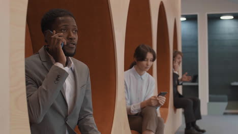 three young businesspeople using smartphones