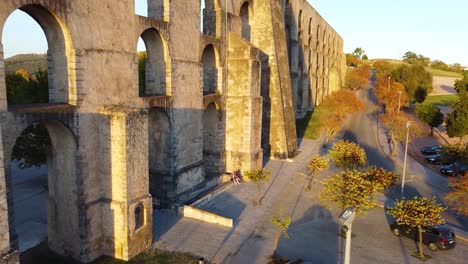 dronie shot of an old aqueduct in elvas, portugal with golden hour lighting