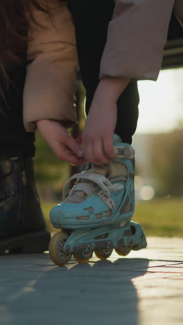 a close-up shot of a person removing their light blue rollerblades and putting on black boots in a park during a sunny day. transition between skating and walking, highlighting the focus on footwear