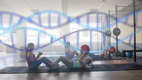 animation of dna strands over diverse women cross training in pairs with medicine balls at gym