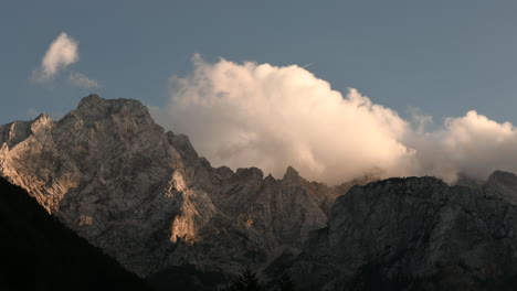 time lapse clouds over mountain peak in sunset, ojstrica in kamnisko savinjske alpe, slovenia, logarska dolina, european alps