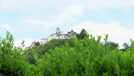 a view from the distance of the sacred mountain of varallo, a christian devotional complex, a unesco world heritage si in italy