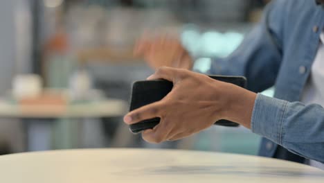 african man checking empty wallet, close up