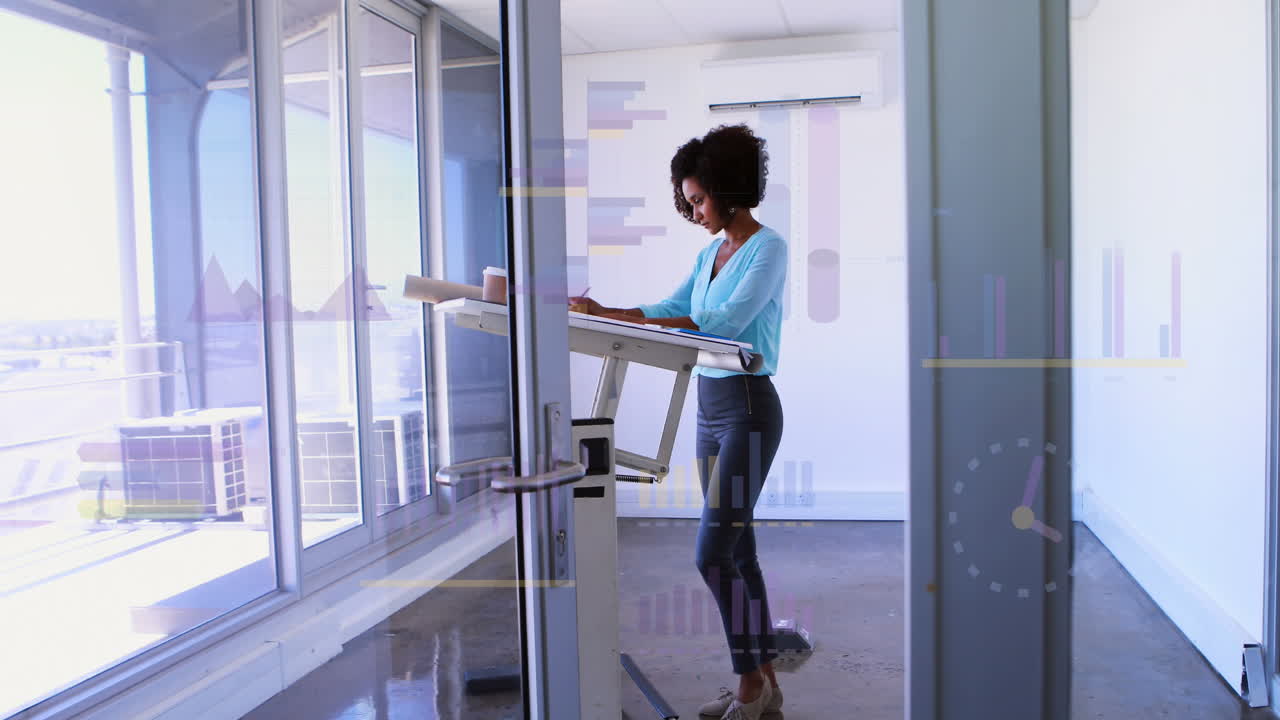 Animation of multiple graphs over biracial female architect preparing blueprint in office