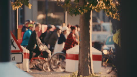 anonymous crowd of people walking cycling bicycles commuters london city street slow motion