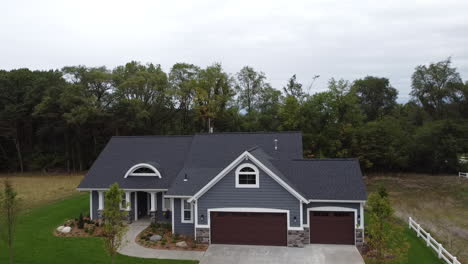 aerial drone bird's eye view blue house michigan suburban suburbs