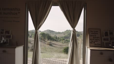 shot of hilly landscape through window