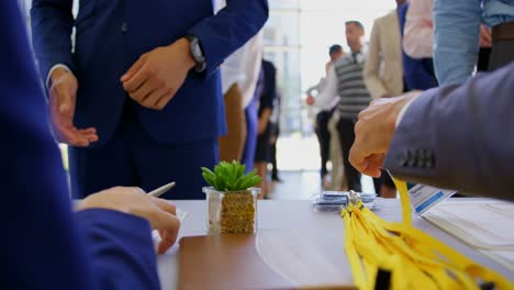 business people checking in at the conference registration table 4k