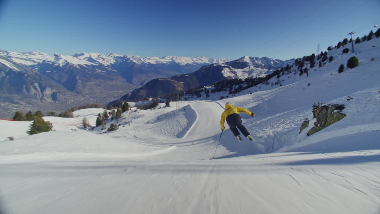 High performance alpine ski carving on groomed pistes in Verbier Bruson and Val de Bagnes filmed with drone and follow cam on a bluebird winter day showcasing fast dynamic fun skiing