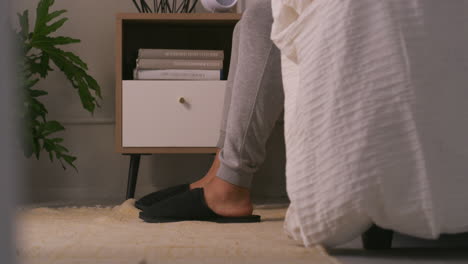 bedroom scene with slippers and nightstand
