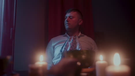 man dining in a dimly lit room