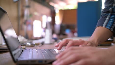 side shot of a man typing on his laptop 4k