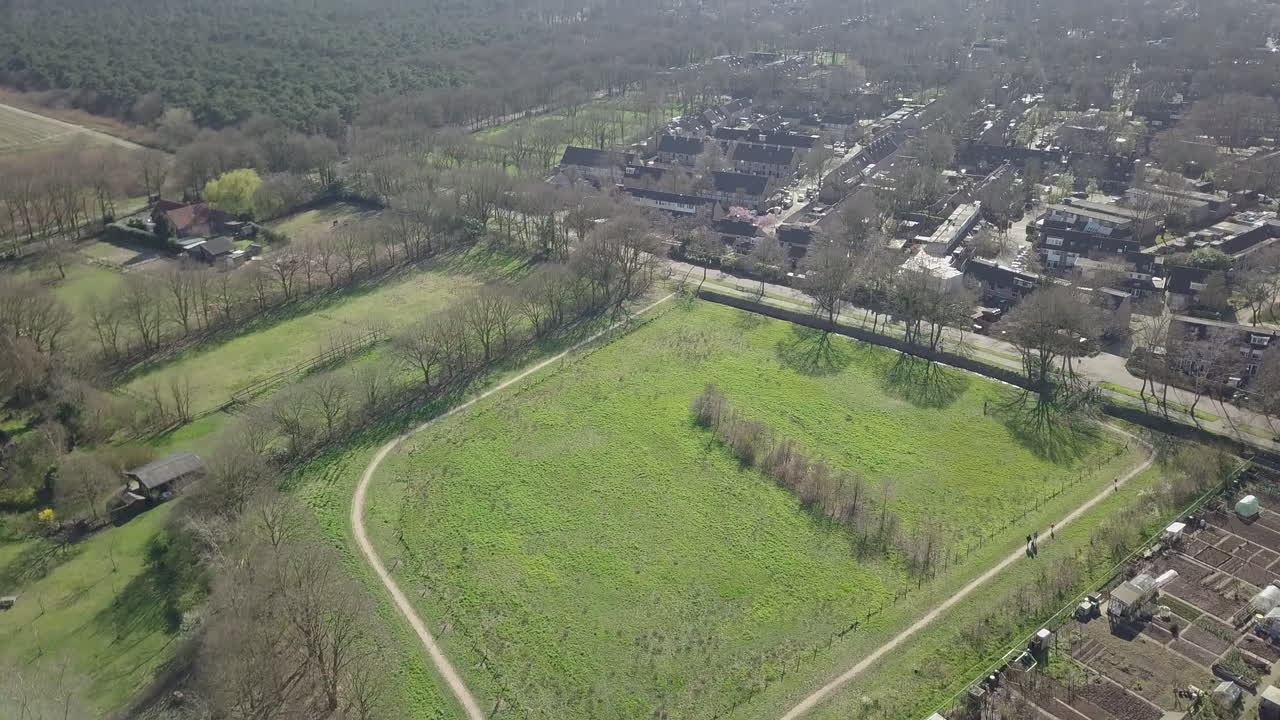 Aerial footage of the flat suburban in the countryside in the winter.