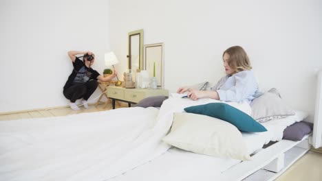 photographer and model in a bedroom