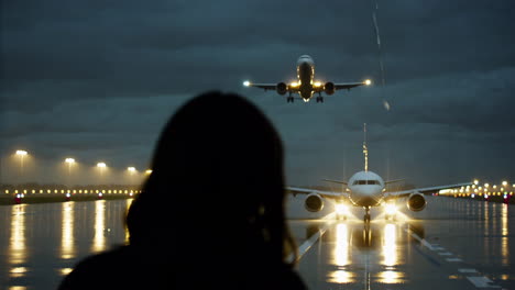 watching planes land at night at the airport