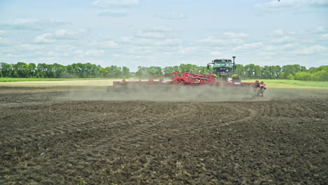 farming tractor plowing field. farming machinery. farming equipment. plowed land