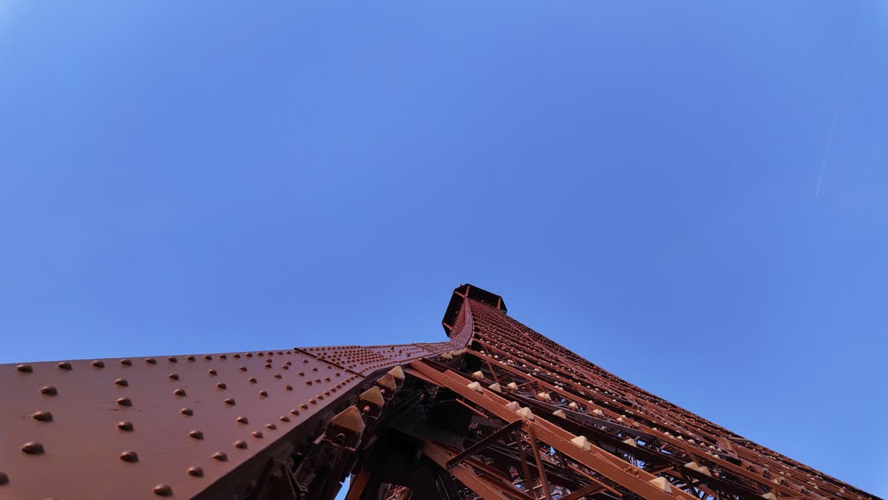 Eiffel Tower Paris France landmark puddle iron structure up-close close up, clear blue sky