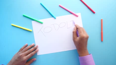 person writing a to-do list