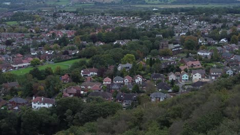 Aerial-view-above-Halton-North-England-coastal-countryside-town-estate-green-space-houses-dolly-left