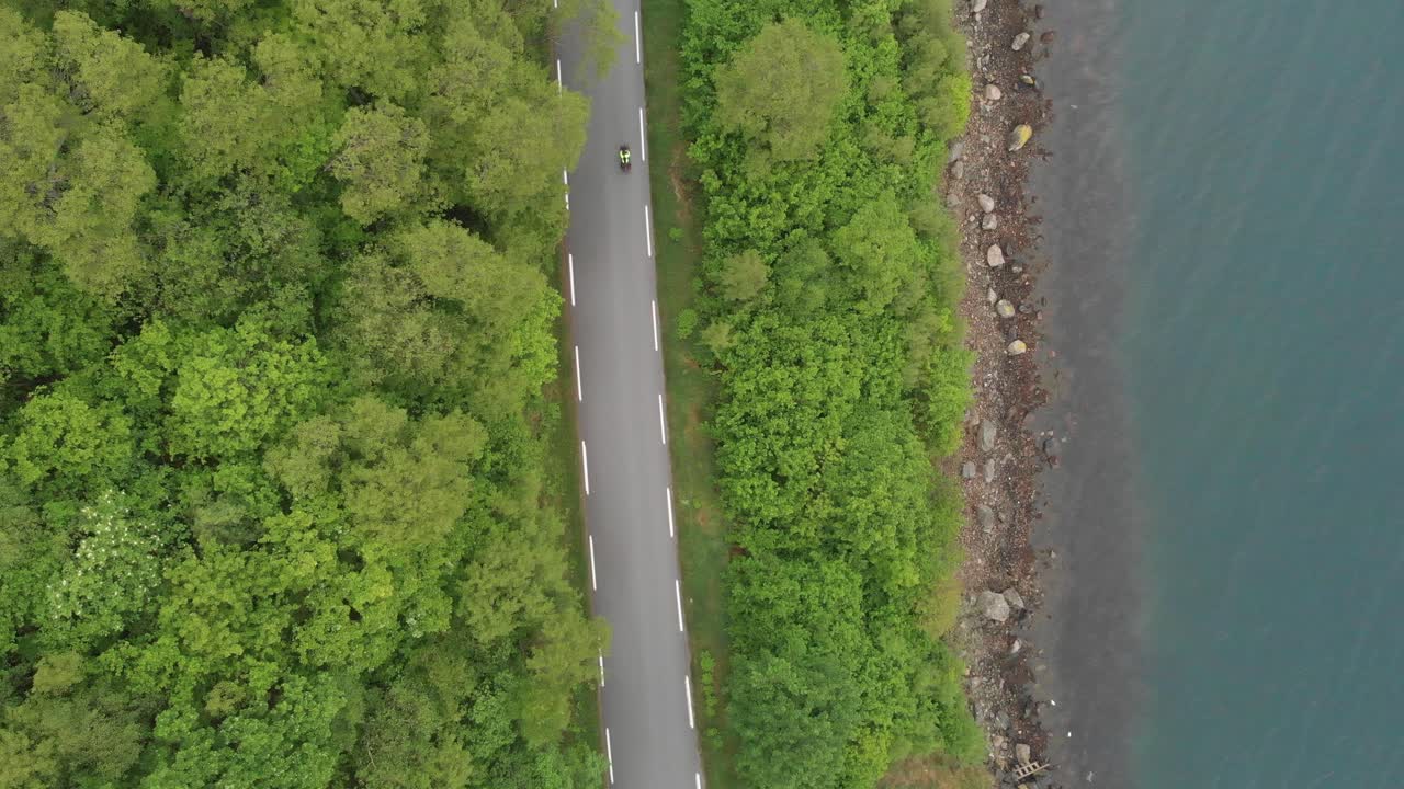 Above View Asphalt Road Through Lush Nature By The River. Aerial Topdown Shot