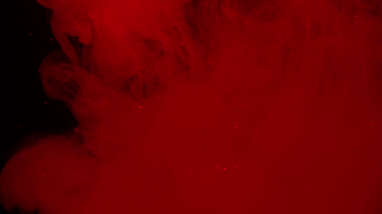 Vortici e particelle di fumo rosso astratto.