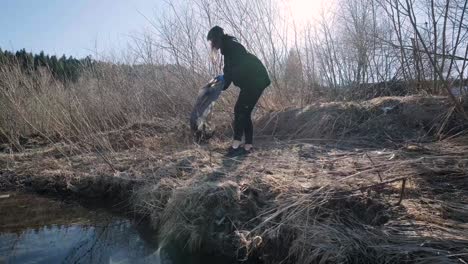 teamwork cleaning plastic on the beach. volunteers collect trash in a trash bag. plastic pollution and environmental problem concept. voluntary cleaning of nature from plastic. greening the planet