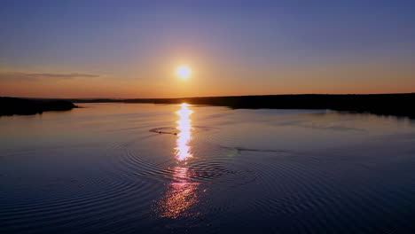 beautiful sunset in nature. sunny path reflects on the river in the evening. amazing view on the lake against the setting sun.
