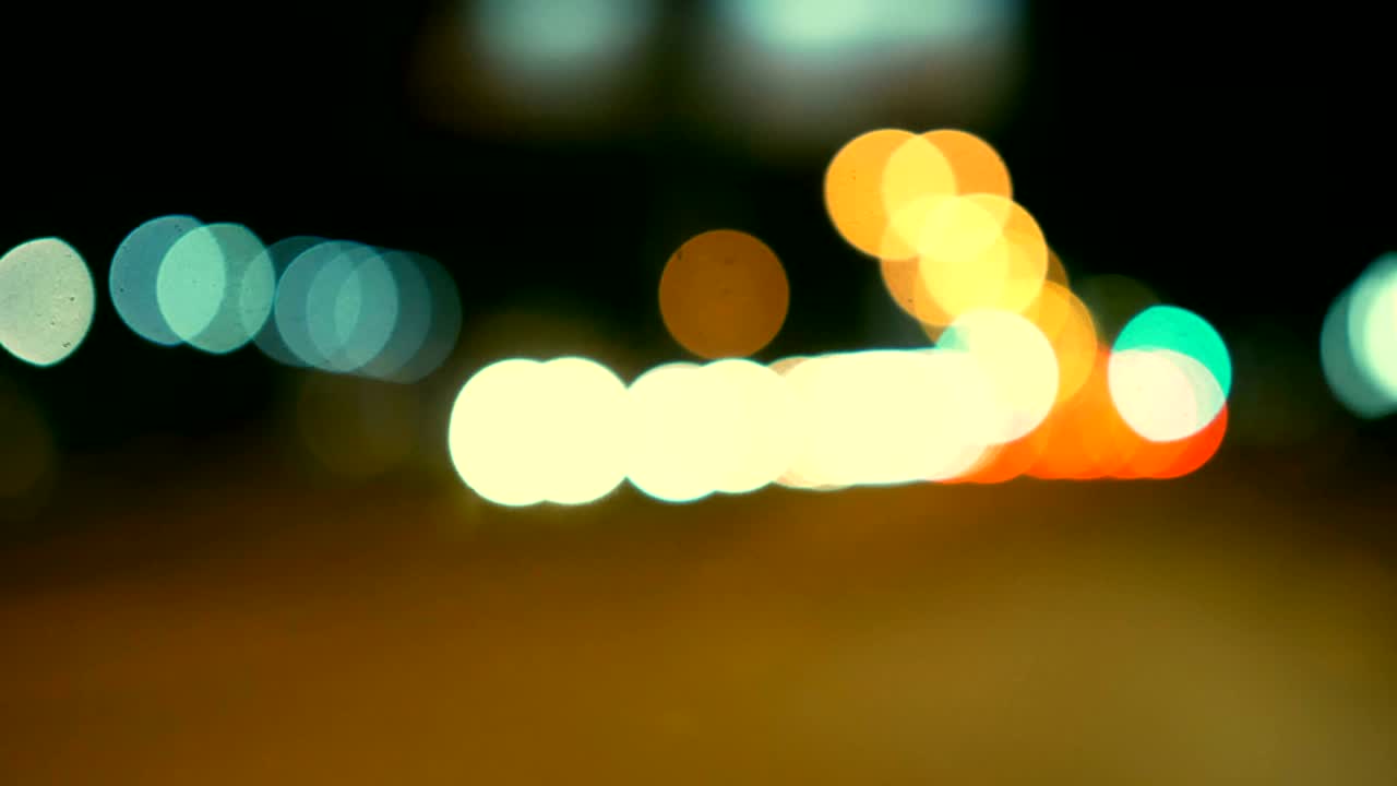 conducir un coche a través de la carretera de la noche, la autopista. luces desenfocadas calle de los ángeles resumen. ciudad fondo borroso. movimientos círculos bokeh de tráfico nocturno.