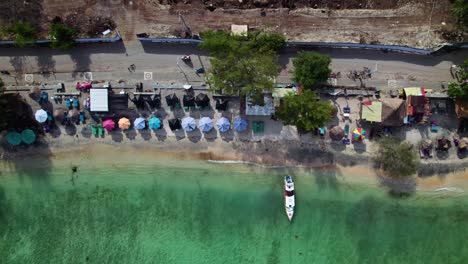 tropical beach filled with small bars gili trawangan coastline, top-down