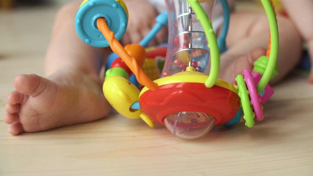 Baby playing with a colorful toy