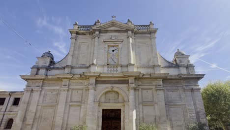 Zoom-on-old-epochal-church-building-made-of-sandstone-with-many-columns-and-an-old-clock-in-a-city-in-France