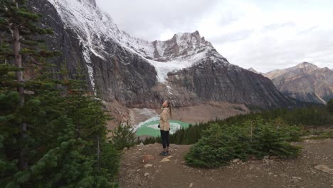 woman looking around enjoying beauty of canadian rockies landscape