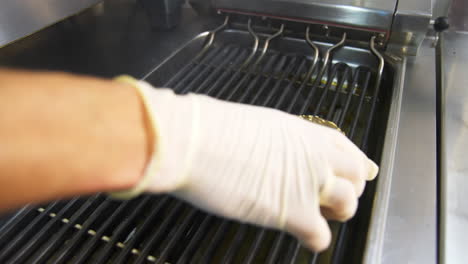 chef cooking hamburger in restaurant. close up of the preparation of magnificent burger in restaurant