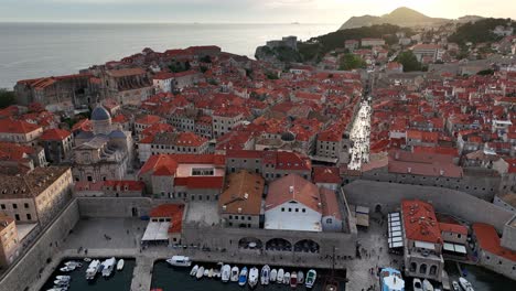 dubrovnik old town in croatia, pan over historic red roofs and harbor, aerial shot