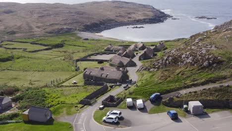 advancing drone shot of the gearrannan blackhouse village on the isle of lewis, part of the outer hebrides of scotland